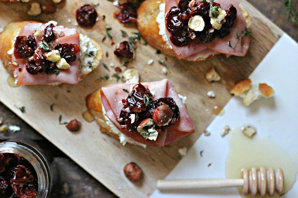 Goat Cheese, Smokey Ham & Wine-Soaked Cherry Crostinis Recipe | HeyFood — heyfoodapp.com