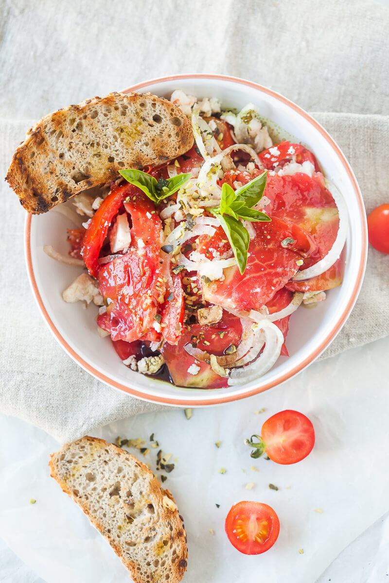 Tomato Salad with Feta Cheese, Onion and Pumpkin Seed Oil Recipe | HeyFood — heyfoodapp.com