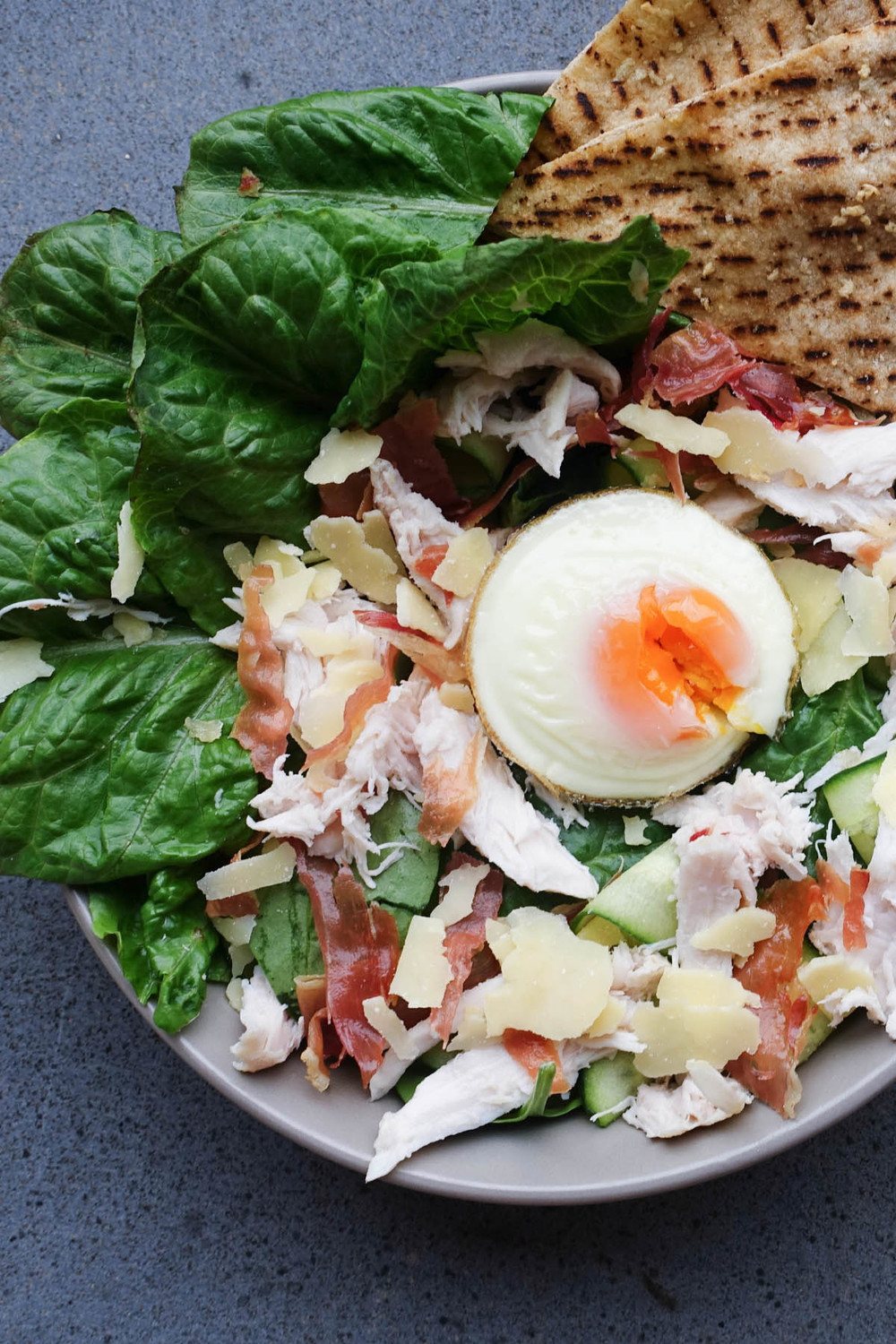 Easy Chicken Caesar Salad with Crispy Garlic Pita Chips Recipe | HeyFood — heyfoodapp.com