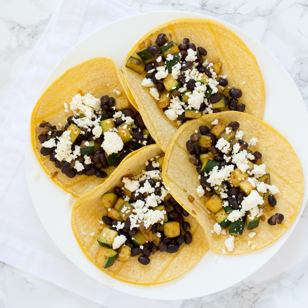 Zucchini & Black Bean Tacos With Feta Recipe | HeyFood — heyfoodapp.com