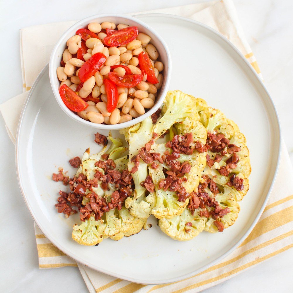 Cauliflower Steaks With Kalamata Vinaigrette & White Bean Tomato Salad Recipe | HeyFood — heyfoodapp.com