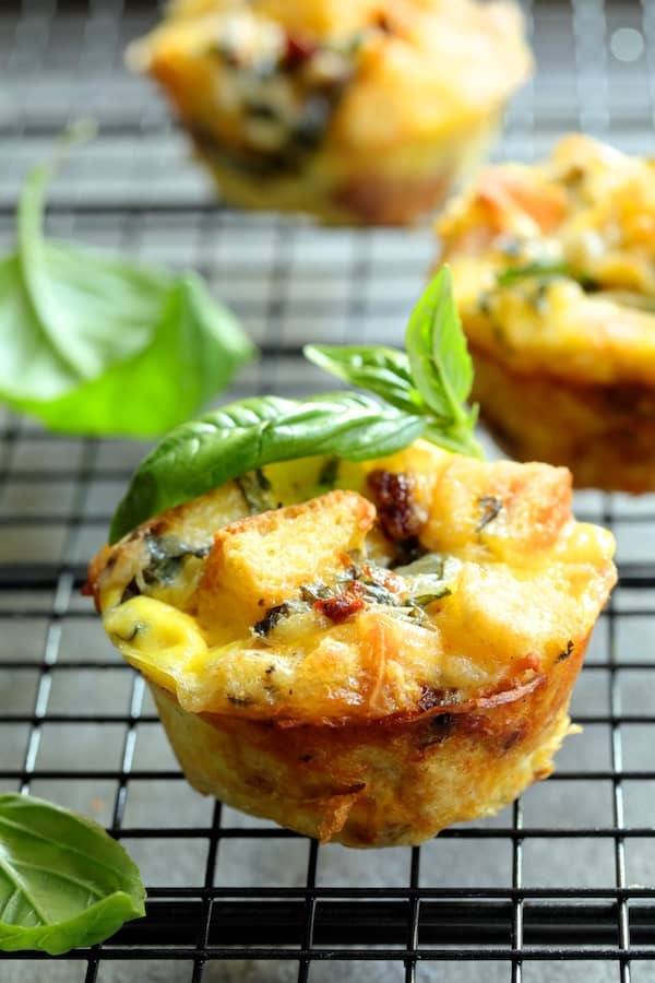 Muffin Pan Stratas with Basil and Sun-Dried Tomatoes Recipe | HeyFood — heyfoodapp.com